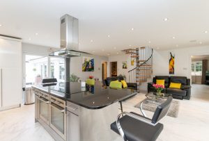 large kitchen island with black granite worktop